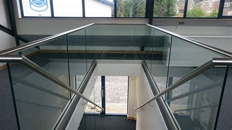 Vertical indoor staircase of commercial building that leads to the balcony glass door. Ballustrade & Stairs/ Glass Roof | Thola IGA