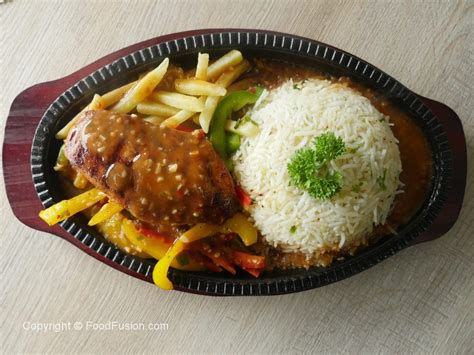 It was created by immigrants from hainan in southern china and. Chicken Sizzler with Garlic rice - Food Fusion