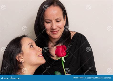 beautiful colombian teenage girl gives her mother a rose on mother`s day stock image image of