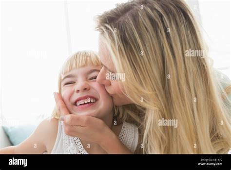 Mother Kissing Happy Daughter On The Cheek Stock Photo Alamy