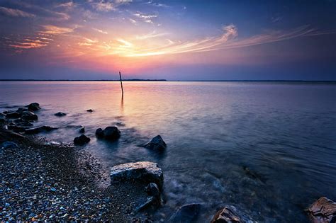Hd Wallpaper Calm Sea With Stones On Seashore Under Blue Sky Peaceful