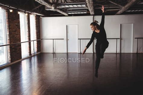 Young Woman Performing Modern Dance In Dance Studio — Stretching