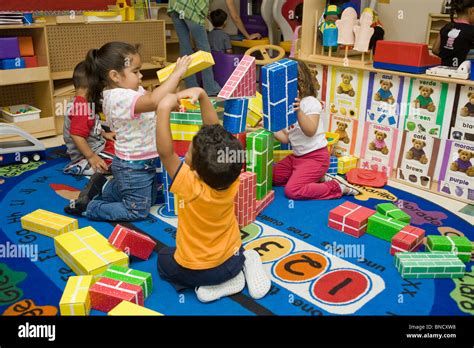 Preschool Children Playing With Blocks On The Floor Stock Photo Alamy