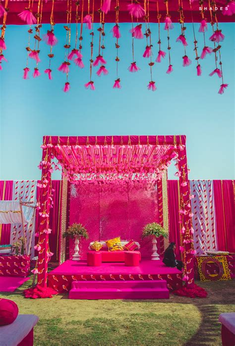Adding the perfect royal touch to the stage backdrop are the upbeat candle holders and a. Pink affair - mehendi decor goals. #indianwedding #wedding ...