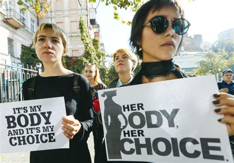 Women Holding Its My Body And Its My Choice Signs During A Protest