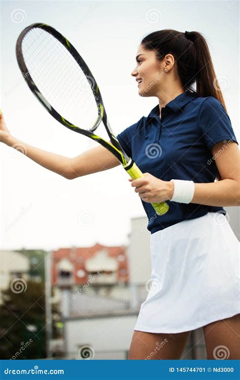 Woman Tennis Player Smiling While Holding The Racket During Tennis