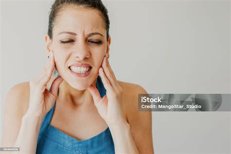 Annoyed Young Woman Suffering From Toothache And Touching Jaw Stock