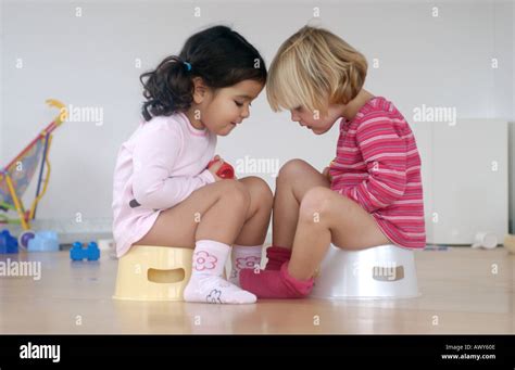 Two Toddler Girls Using A Potty Stock Photo 3110413 Alamy
