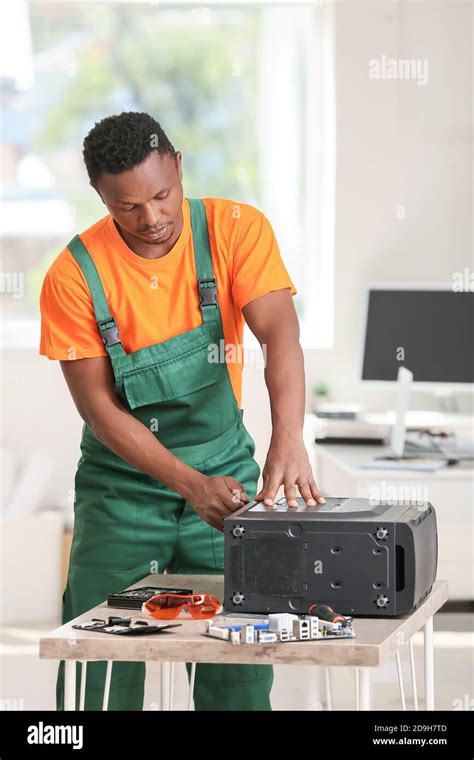 African American Technician Repairing Computer In Service Center Stock