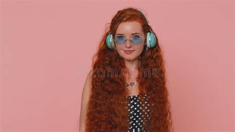 Young Redhead Woman In Dress Listening Music On Headphones Dancing Disco Fooling Around Having