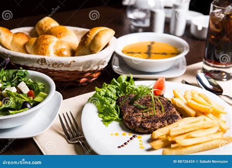 Main Course Soupe Salad Bread And Drink For Dinner Stock Photo
