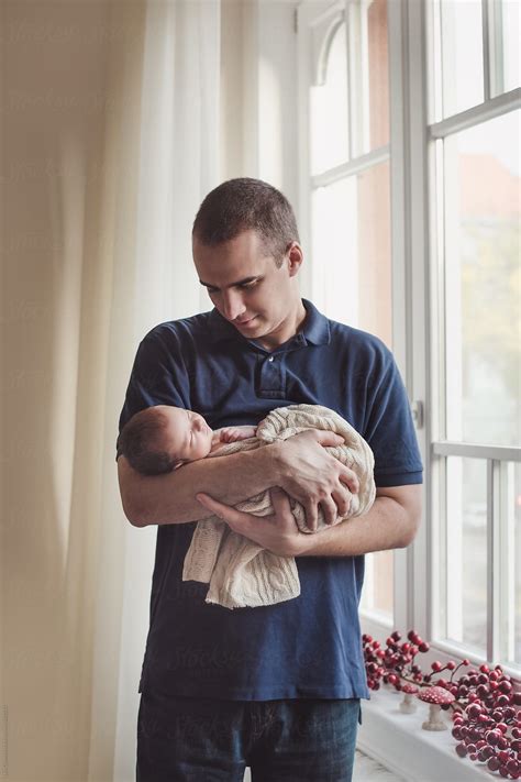 New Father Holding His Sleeping Newborn Baby In His Arms Del Colaborador De Stocksy Lea