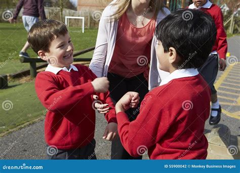 Teacher Stopping Two Boys Fighting In Playground Stock Photo Image Of