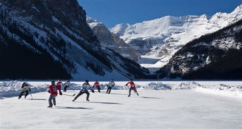 Hockey Players Playing On The Frozen Lake Louise Mount Victoria Banff