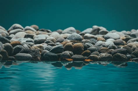 Beautiful Shot Of Resting Water Reflecting The Rocks Ghessu