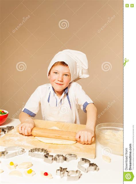 Smiling Boy In Baker S Uniform Flatenning Dough Stock Image Image Of