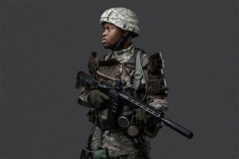 African Army Soldier With Rifle Posing Against Dark Background Stock