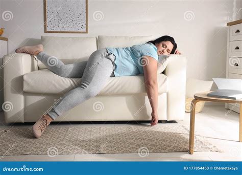 Lazy Overweight Woman With Chips Watching Tv On Sofa Royalty Free Stock