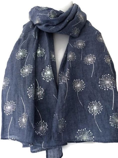A Blue Scarf With White Dandelions On It