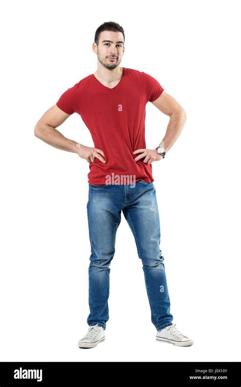 Young Cool Relaxed Guy With Hands On Hips Looking At Camera Full Body