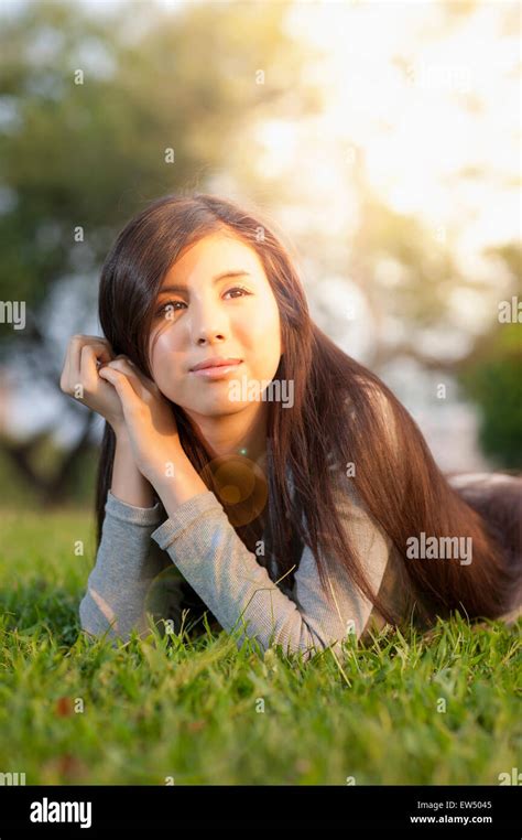 Young Woman Lying On Front And Looking Away With Smile Stock Photo Alamy