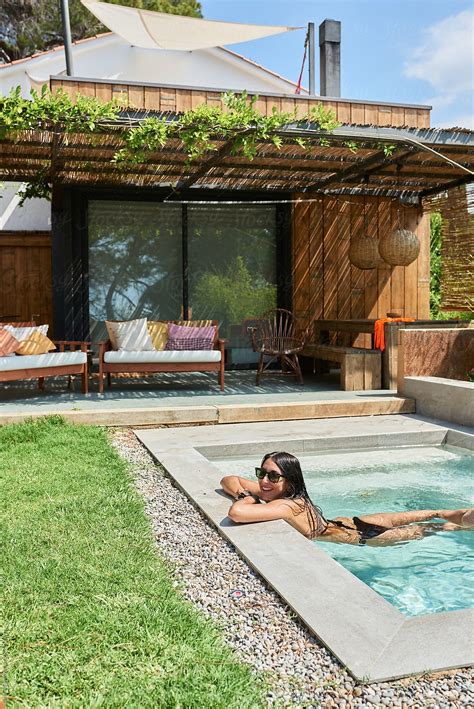 Smiling Happy Brunette In Swimming Pool On Backyard By Stocksy Contributor Guille Faingold