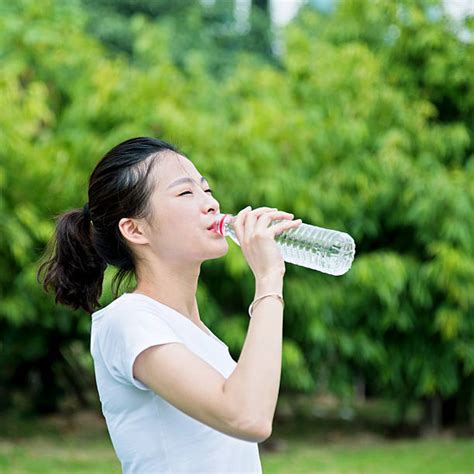 Asian Woman Drinking Water Bottle Stock Photos Pictures And Royalty Free