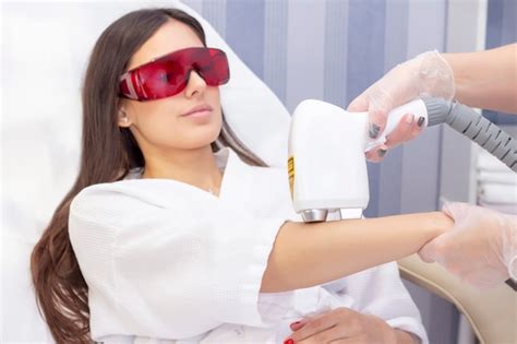 Laser Hair Removal And Cosmetology The Woman Removes Hair On Her Arm