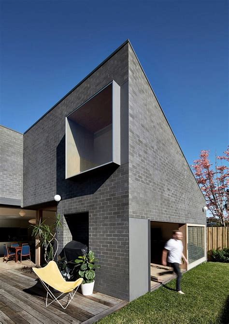 This Black Brick House Features Generous Spaces with a High Degree of ...