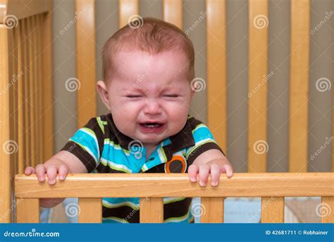 Crying Baby Standing In His Crib Stock Image Image Of Human Face