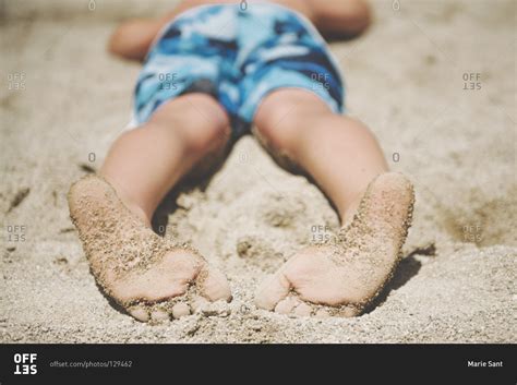 Close Up Of The Sandy Feet Of A Boy At A Beach Stock Photo Offset