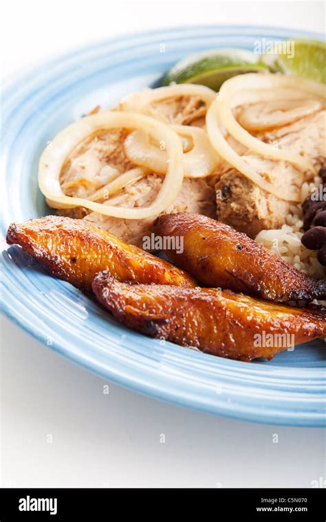 Plate Of Cuban Food With Fried Sweet Plaintains Roast Port And Black