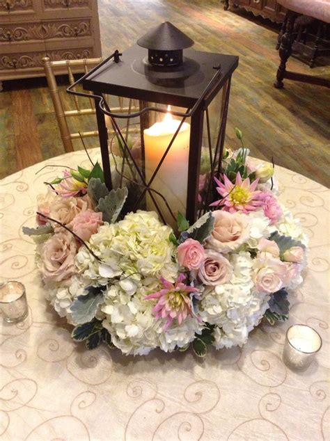 A Beautiful Lantern Centerpiece Surrounded By White