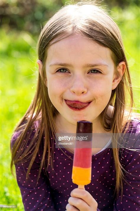 Portrait Of Girl With Ice Lolly Licking Lips Photo Getty Images