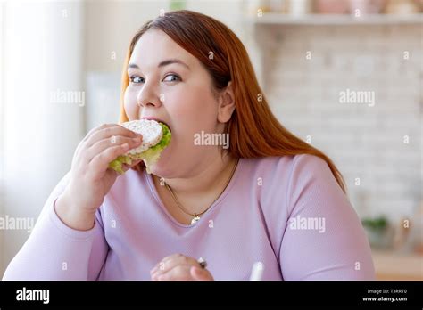 Pleasant Plump Woman Eating A Healthy Sandwich Stock Photo Alamy