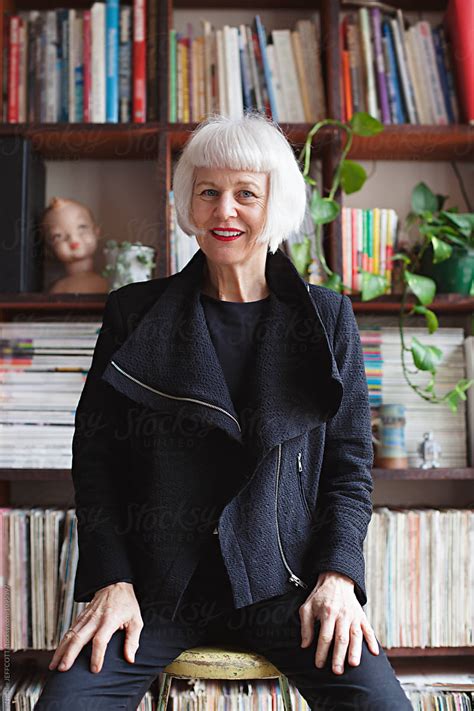 Stylish Older Woman Indoors In Front Of Books And Records By Stocksy