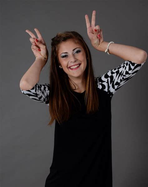 Woman Smiling And Doing Peace Signs · Free Stock Photo