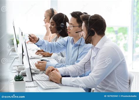 Customer Support Service Hotline Operator Helping His Colleague At