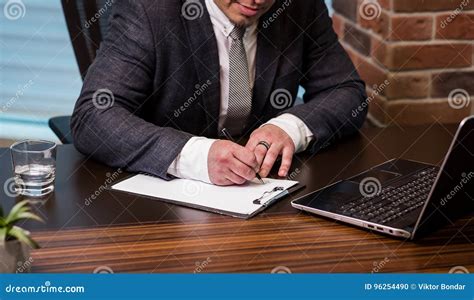 Close Up Businessman Signing Documentsbusinessman Is Signing A Stock