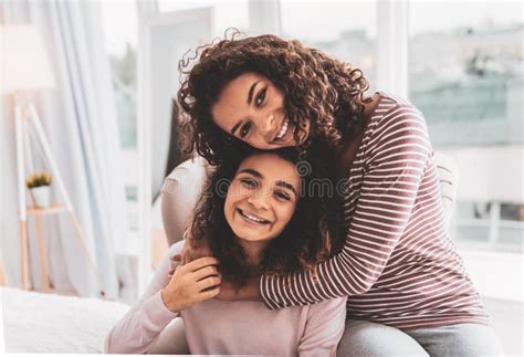 Dark Haired Girl Feeling Loved While Hugging Her Caring Sister Stock