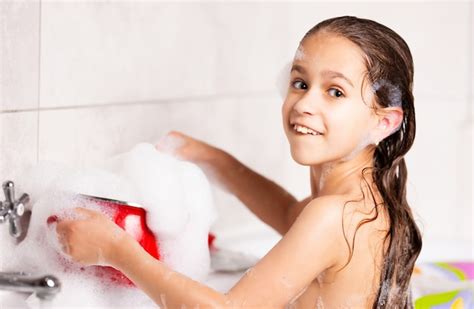 Premium Photo Cheerful Little Caucasian Girl Plays With Foam While Bathing In The Bathtub