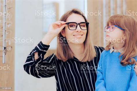 Mother And Daughter Wearing Eyeglasses In An Ophthalmology Clinic Stock