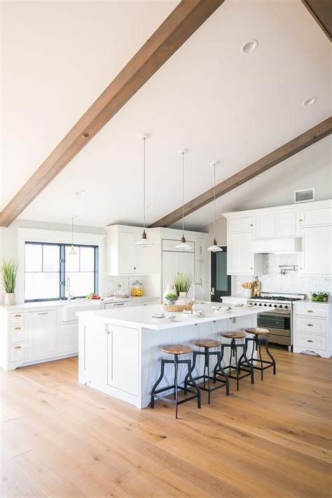 Find kitchen island lighting at wayfair. Hung from a vaulted ceiling accented with wood beams ...