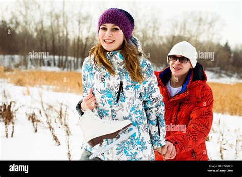 Caucasian Couple Carrying Ice Skates In Snowy Field Stock Photo Alamy
