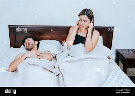 Husband Snoring While The Wife Suffers And Covers Her Ears Sleep Apnea