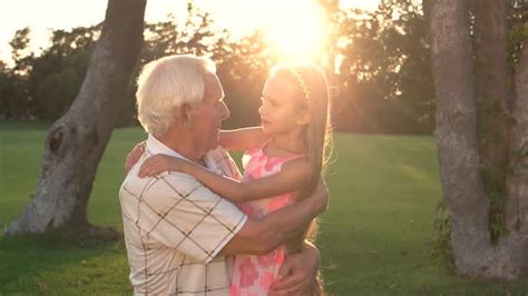 Conversation Between Grandpa And Granddaughter Outdoors By Stockfilmstudio