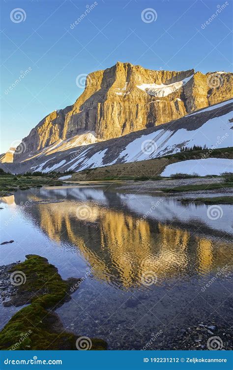 Scenic Mountain Peak Sunlight Reflected Calm Water Dramatic Sunset