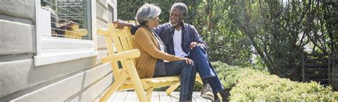 Senior African American Couple Sitting On Porch Outside House