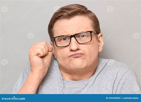 Portrait Of Funny Disgruntled Man Shaking Fist In Threatening Gesture
