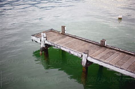 A Small Wooden Pier Or Wharf In A Lake Del Colaborador De Stocksy